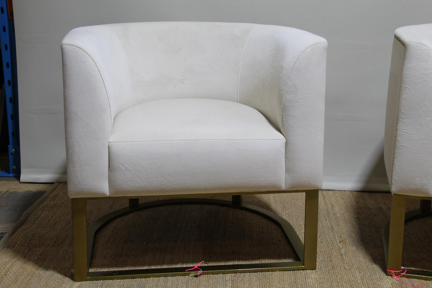 White barrel chairs with brass base made by Interdesign